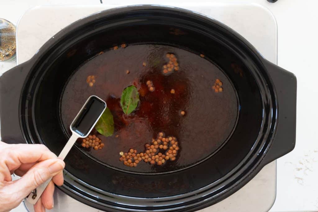 Add soy sauce to crock pot.