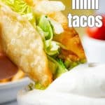 Mini Tacos dipped in sour cream.