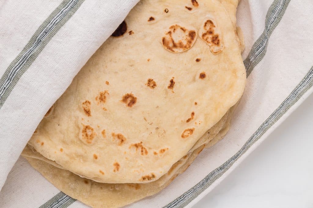 Keep cooked tortillas warm in a dishtowel.