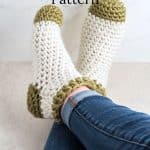 Crocheted slipper socks on feet.