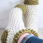 Crocheted slipper socks on feet.