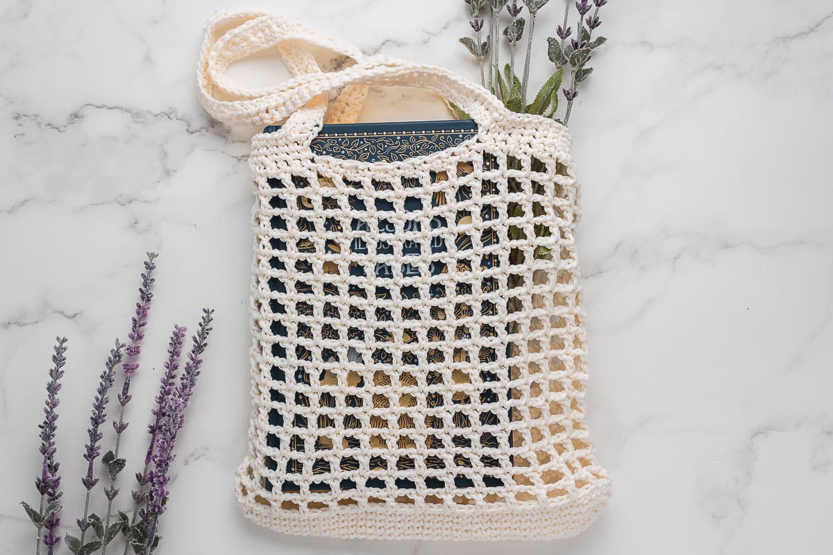 Crocheted Market bag with book inside.