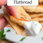 Sourdough flatbread dipped in white sauce.