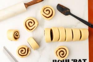 Cut cinnamon roll dough.