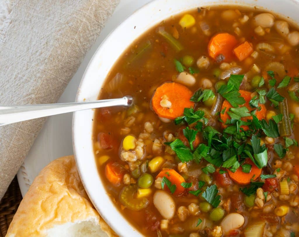 Vegetable and Barley Soup in a white bowl.