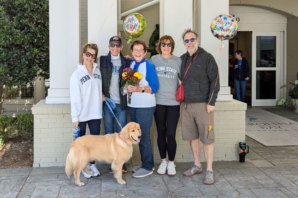 family holding balloons.