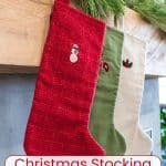 Three embroidered Christmas stockings hanging on a mantle.