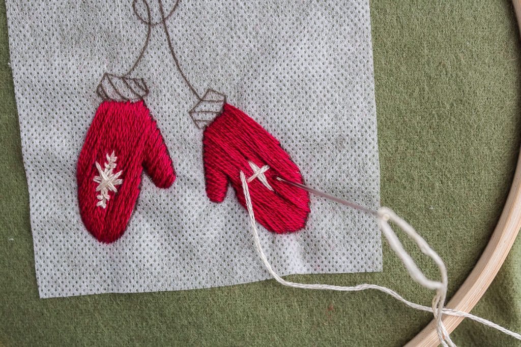 Embroidering mittems.