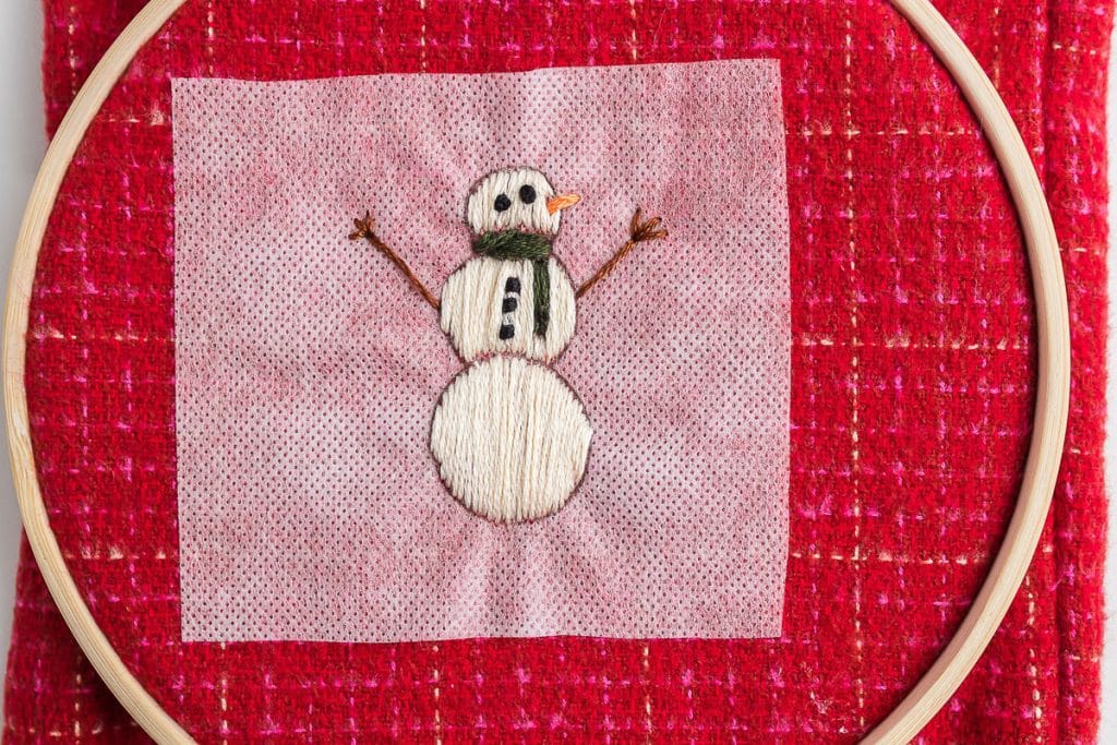 sewing arms of snowman.