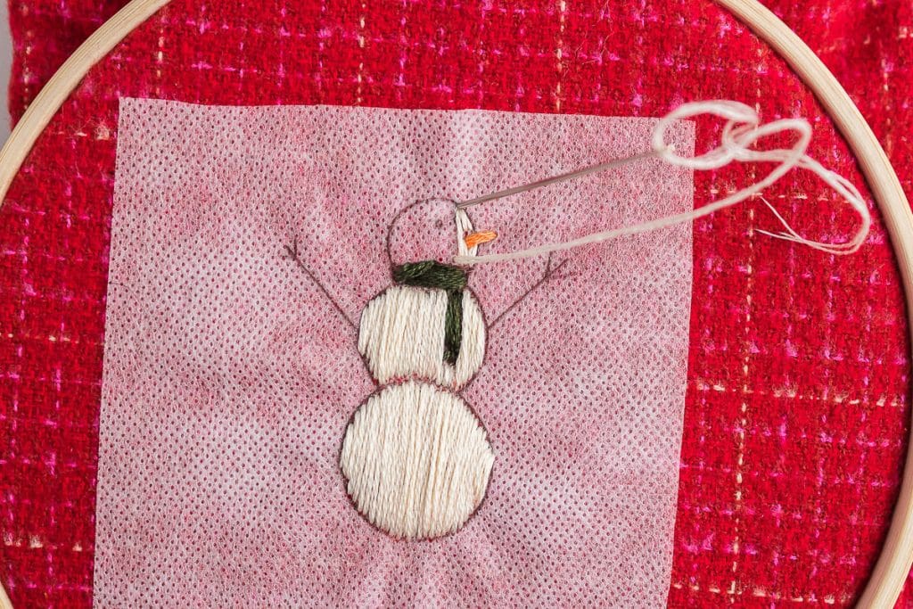 sewing body of snowman.