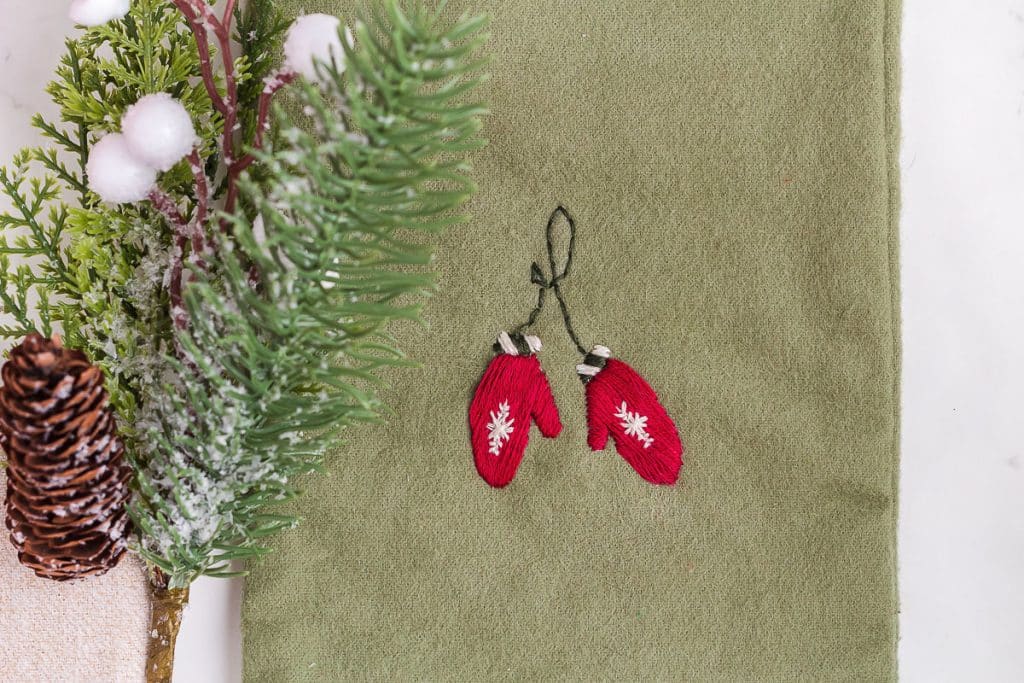 Closeup of mitten embroidery on Christmas Stockings.