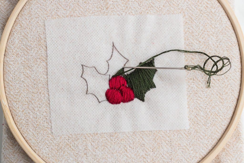 Embroidering holly.