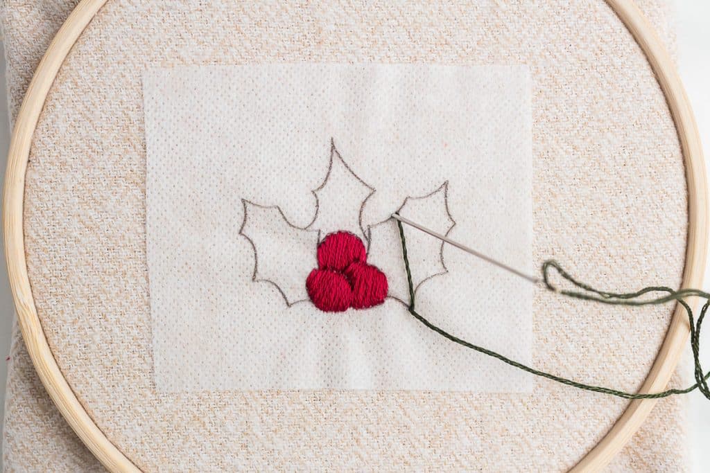 Embroidering holly.