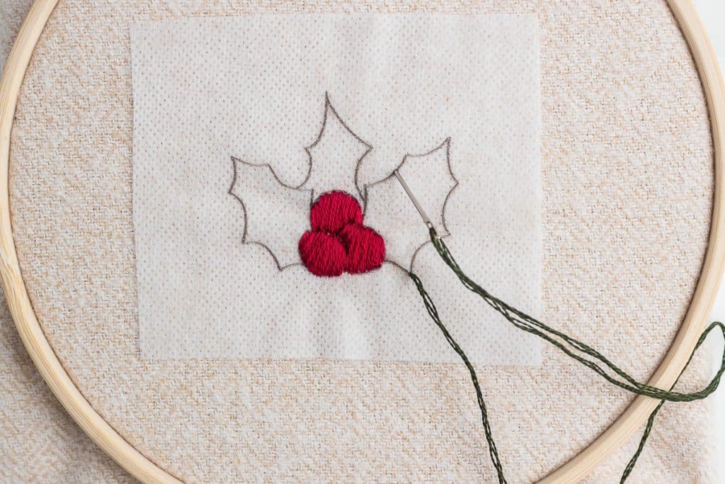 Embroidering holly.