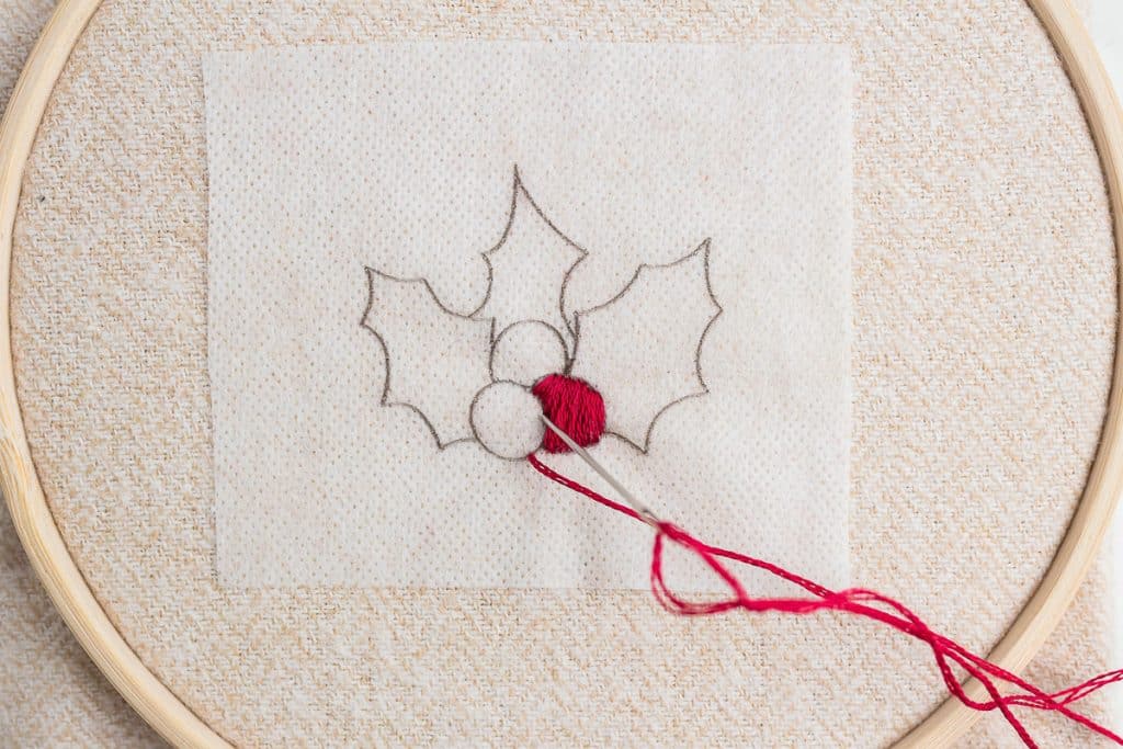 Embroidering holly.