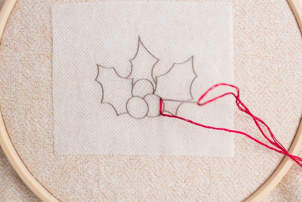 Embroidering holly.