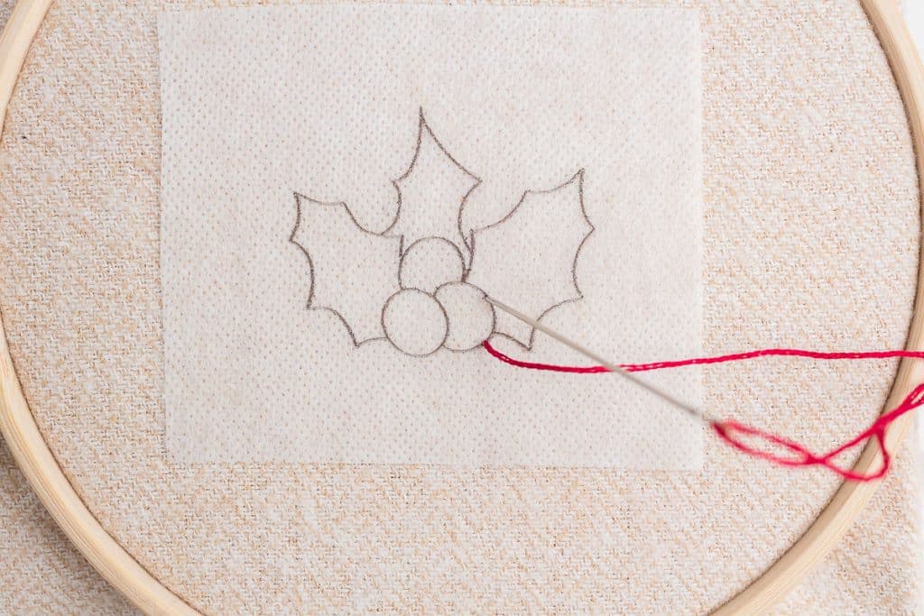 Embroidering holly.