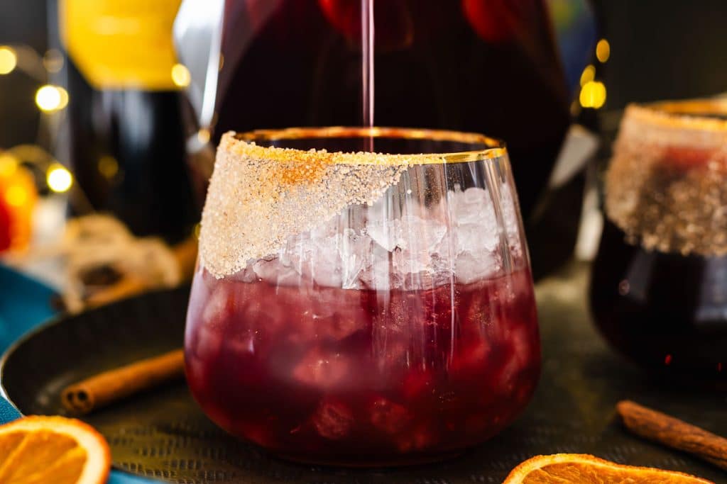 Pouring Sangria in a glass in ice.