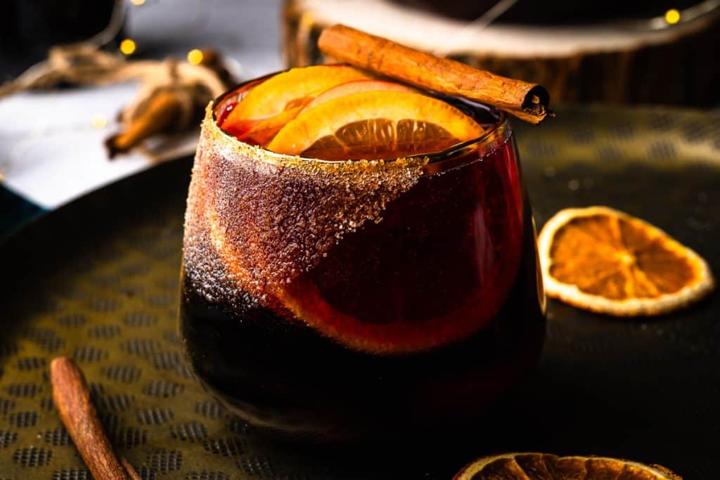 Winter sangria with orange slices and cinnamon sticks.