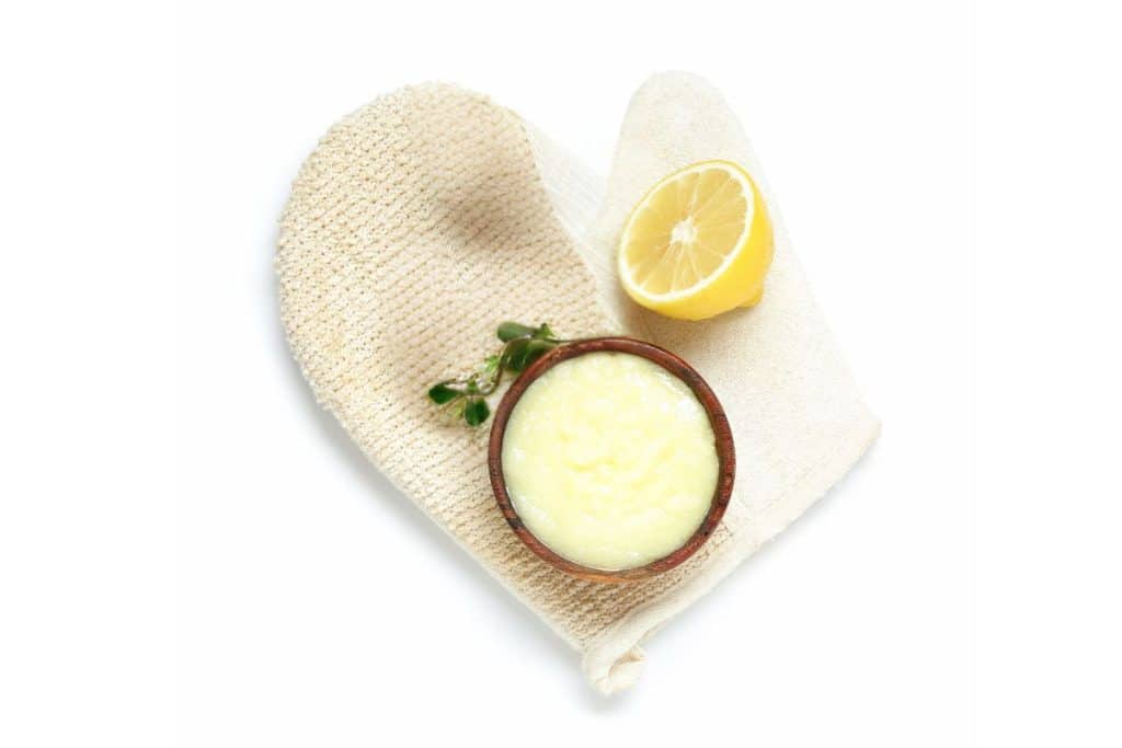 lemon sugar scrub with a scrub glove.