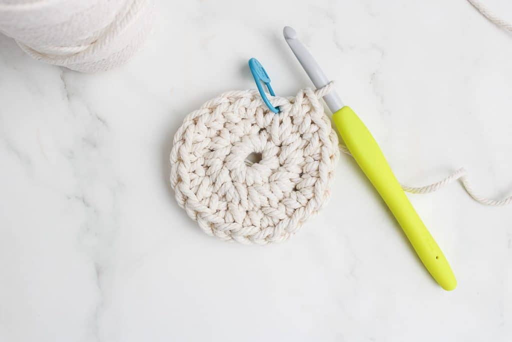 Crochet hook and rope working on magic circle.