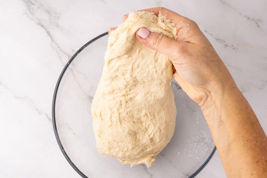 Pick up one side of the dough and fold it over itself.