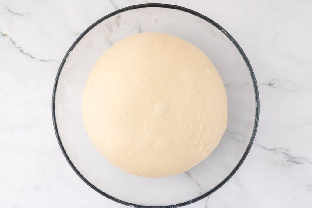 IMage of dough in bowl after 4 hours of bulk fermentation following this easy sourdough bread recipe.