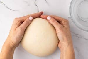 shaping dough with your hands.