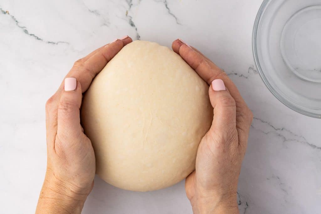 shaping dough with your hands.