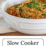 Slow cooker pork casserole in a white bowl on a slab of wood.