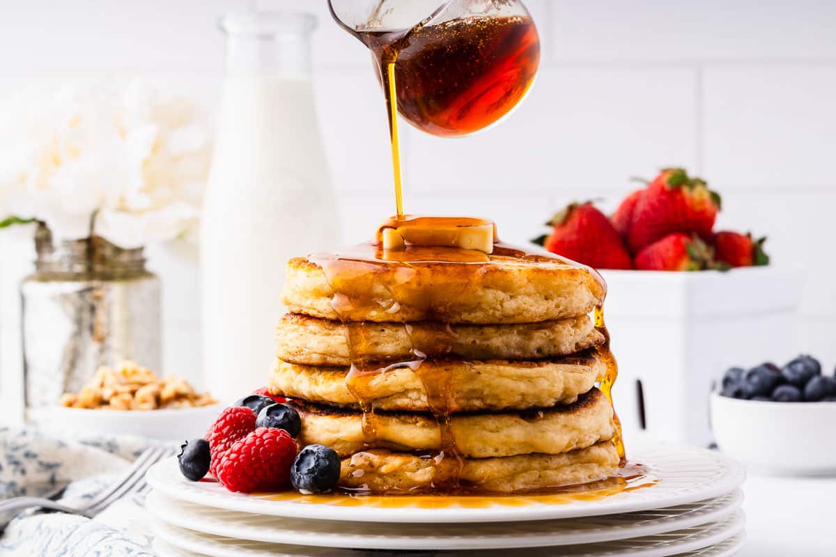 Syrup pouring over sourdough discard pancakes.