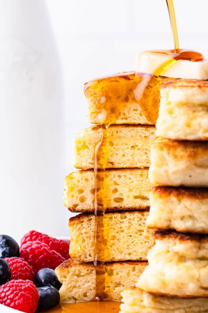 Syrup pouring over sourdough discard pancakes.