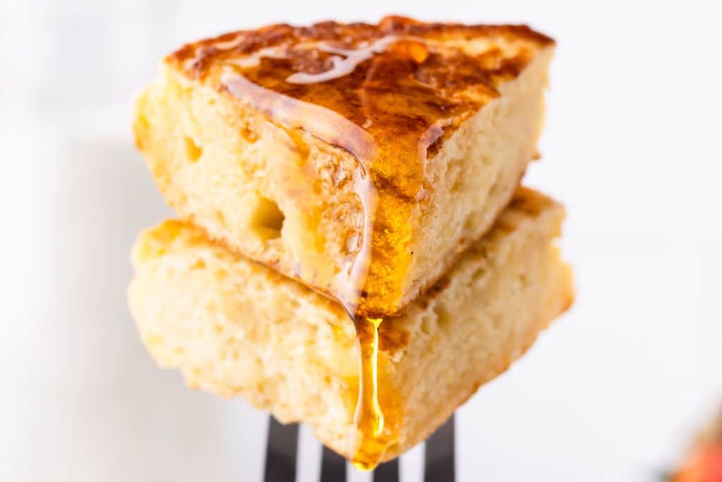 Syrup pouring over sourdough discard pancakes.