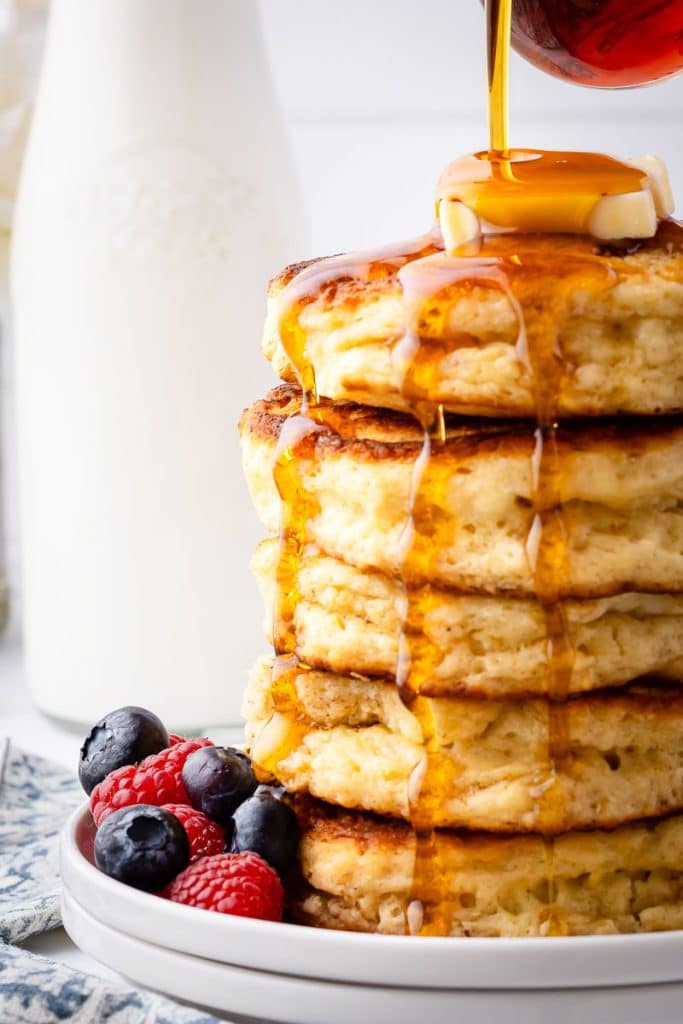 Syrup pouring over sourdough discard pancakes.