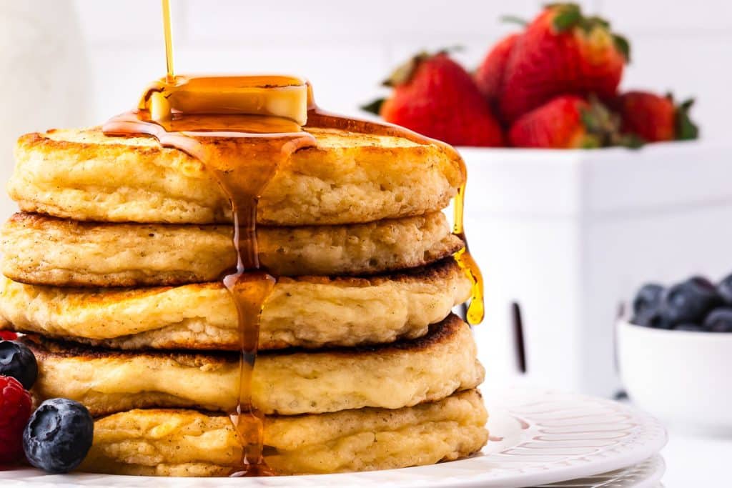 Syrup pouring over sourdough discard pancakes.