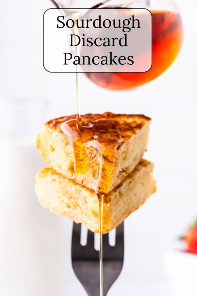 Stack of pancakes on a fork with syrup.