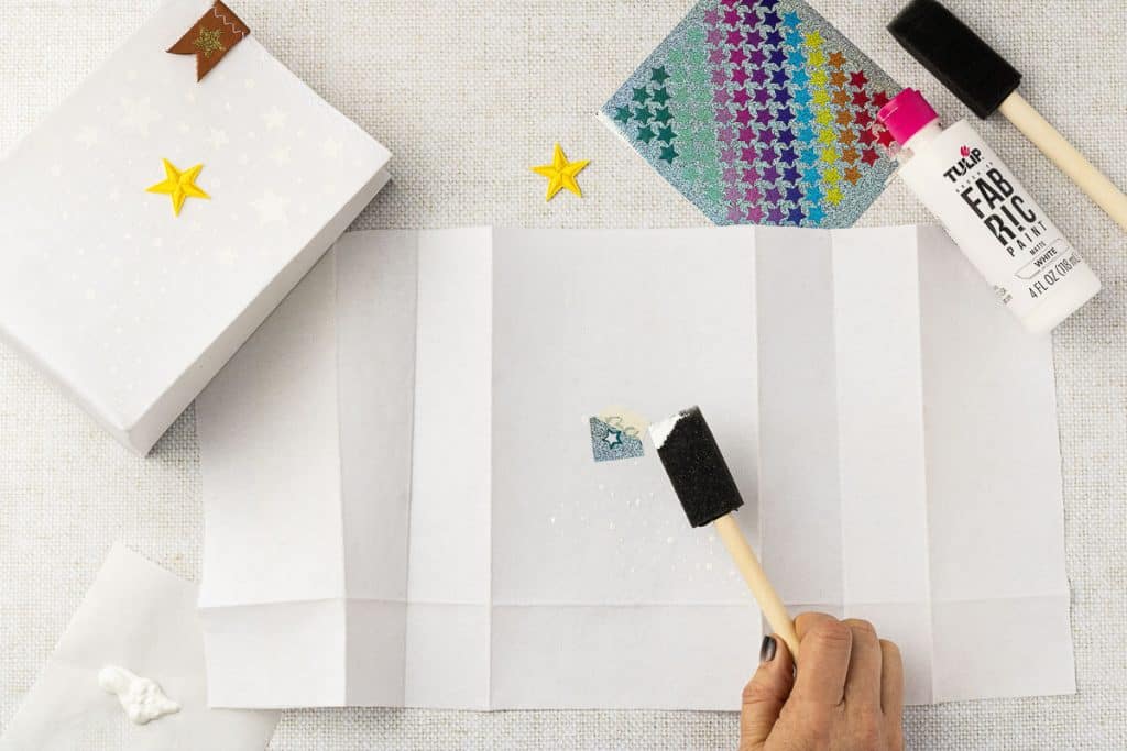 Using sticker to paint stars.