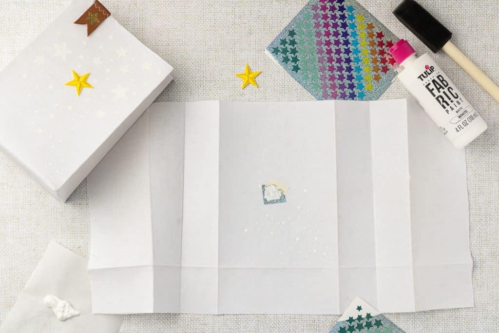 Using stickers to paint stars.