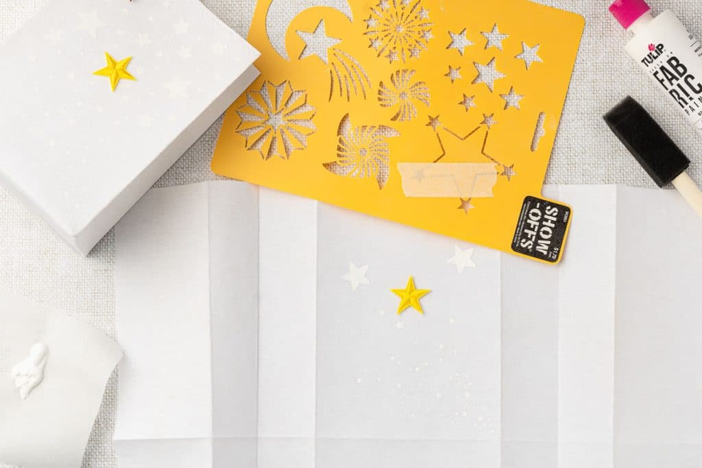 Using stencil to blog part of bag.