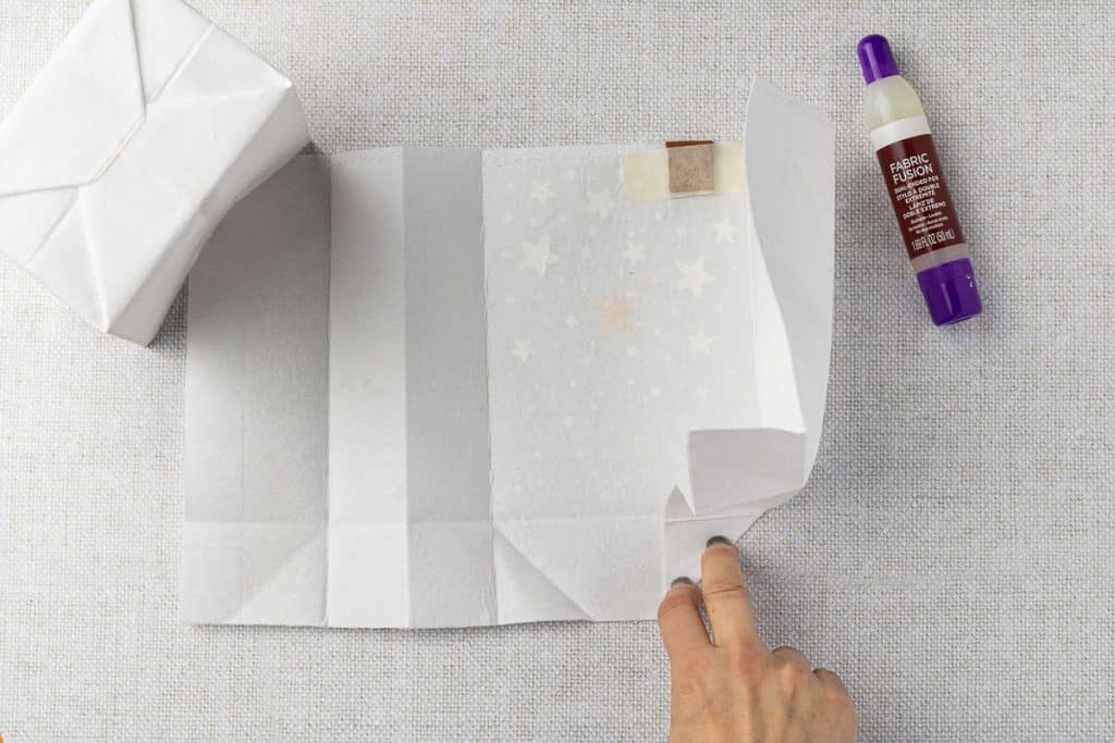 Folding bottom of bag.