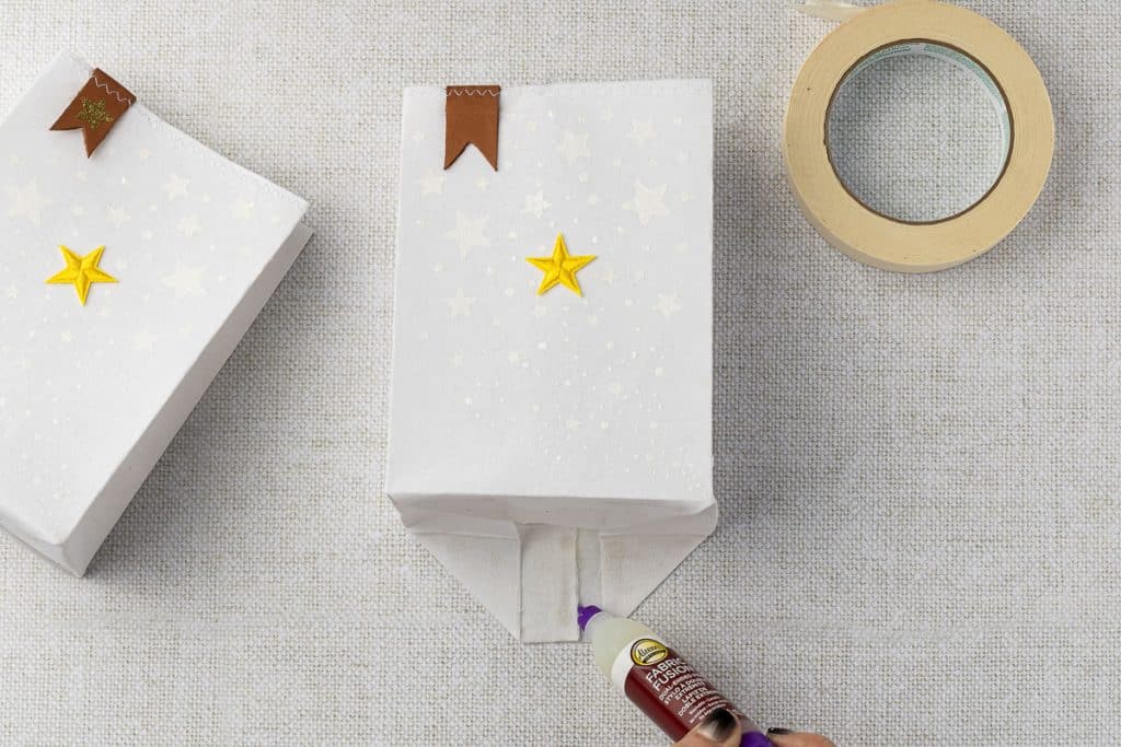 Gluing bottom of bag.