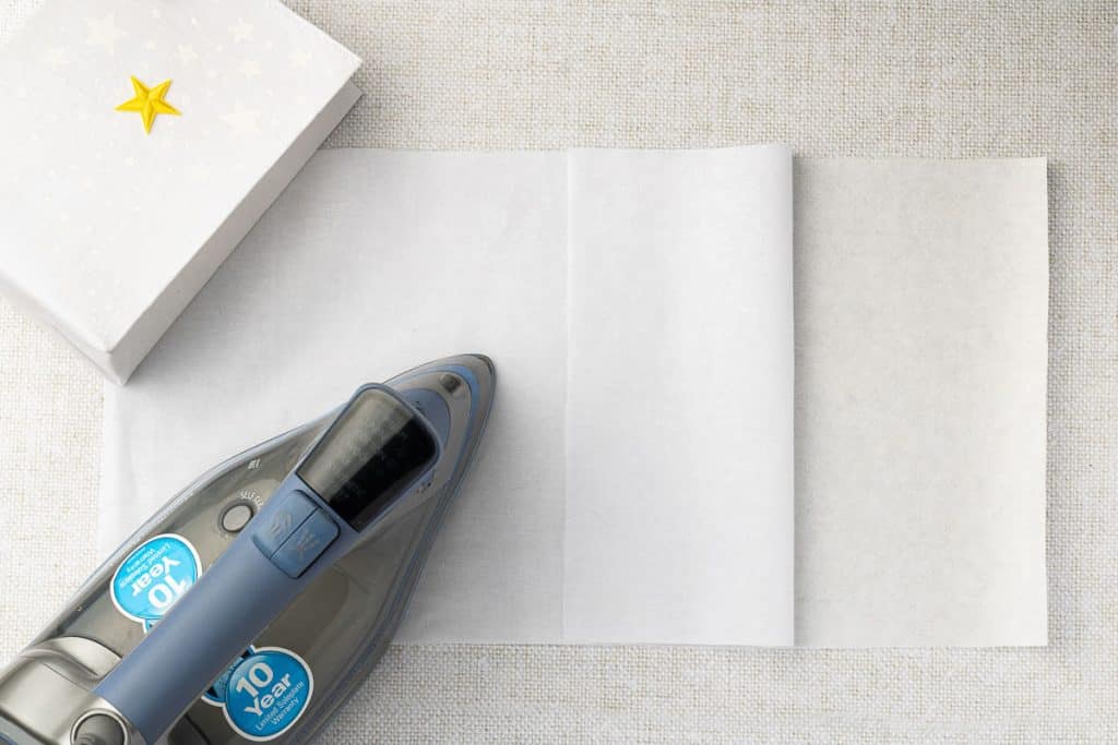 Iron two pieces of fabric together.