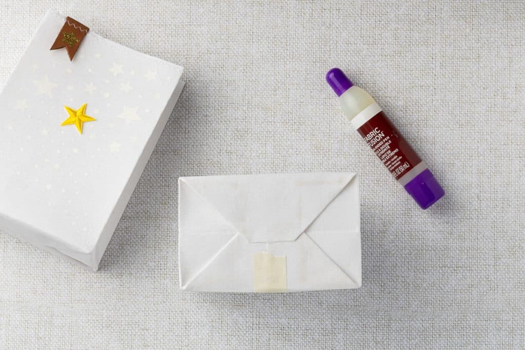 Folded bottom, taped together to hold it together.