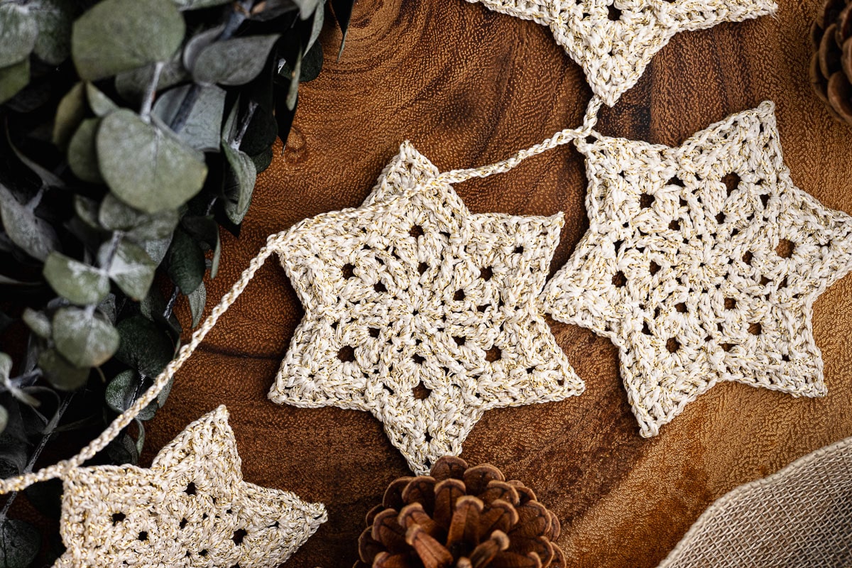 Crochet Star Garland on wood surface.