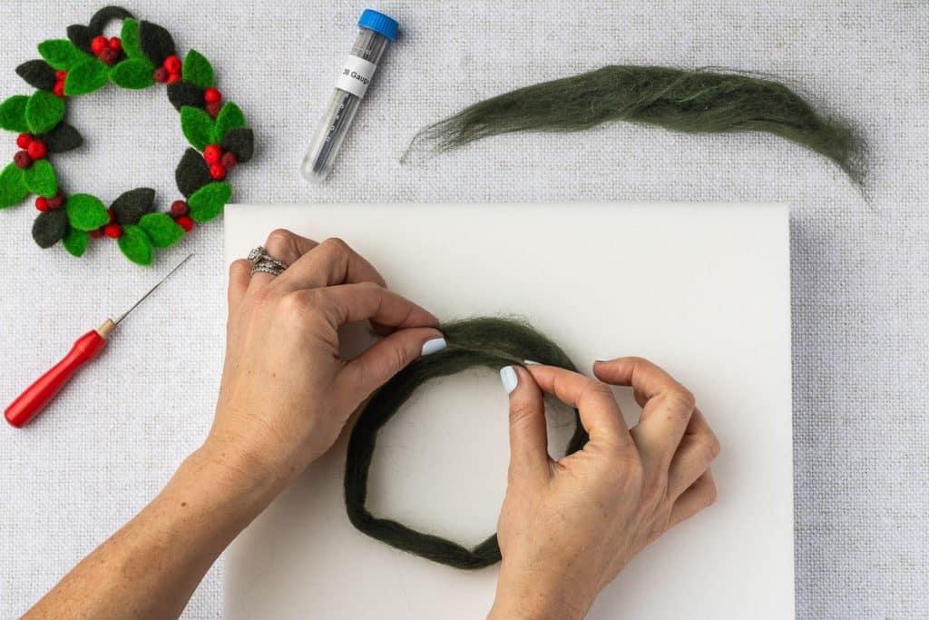 Forming shape of wreath.