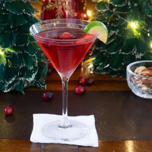 Holiday Cosmo in front of feather Christmas trees