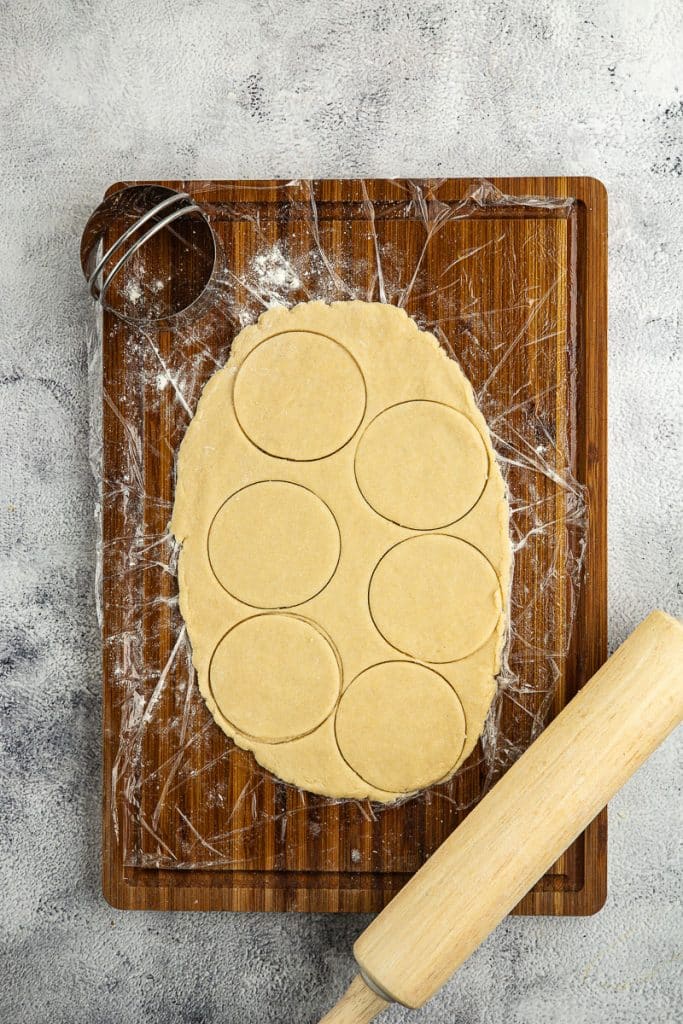 roll and cut sugar cookie dough.