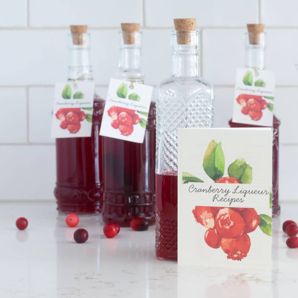 cranberry liqueur bottles with tags and recipe booklet.