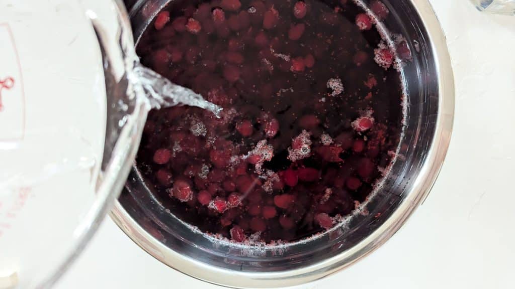 Pour vodka into cooked cranberries.