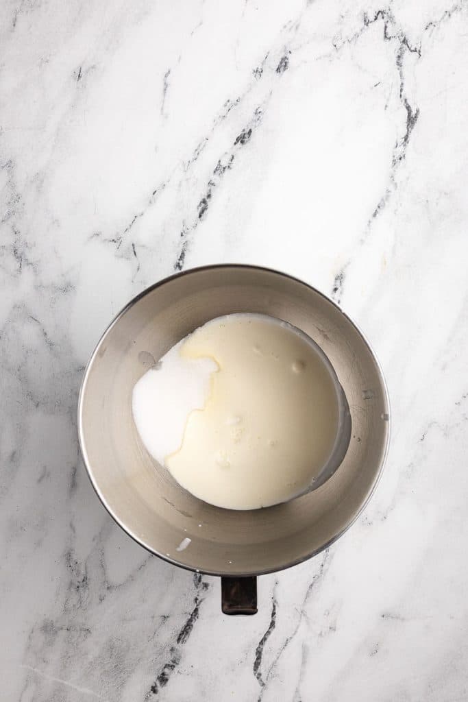 Whipping cream and sugar in a bowl.